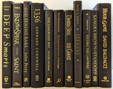 Black books with gold titles by the foot for decor